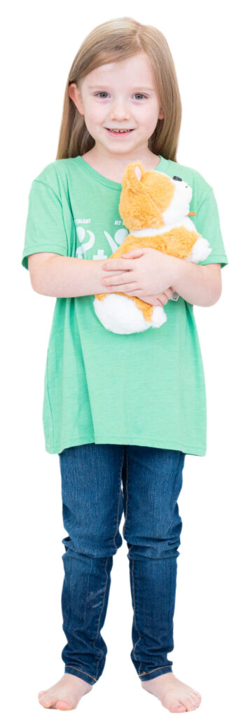Pre-K girl holding corgi stuffie.